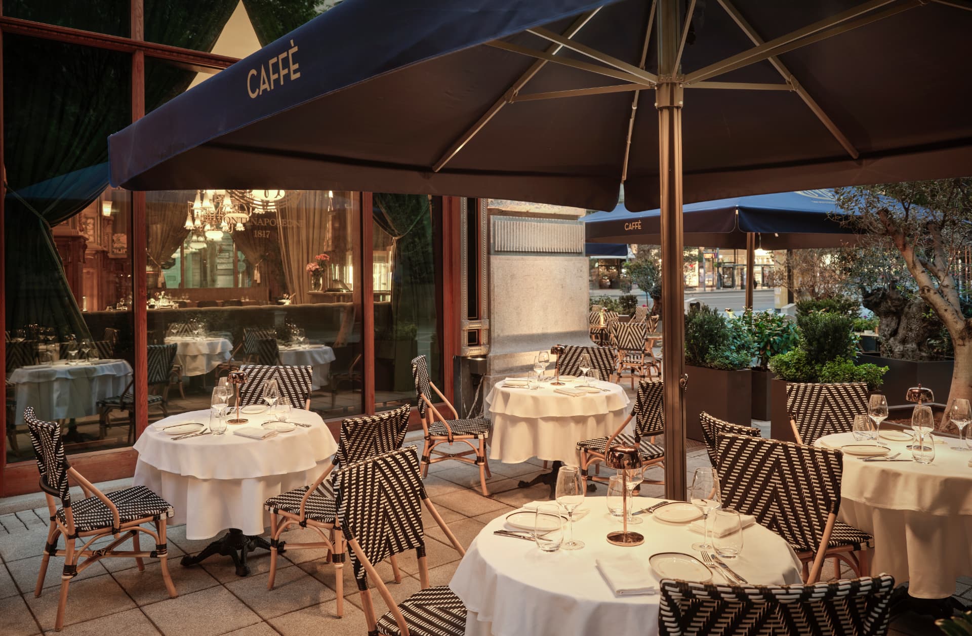 Terrace seating at Cova Budapest under elegant navy umbrellas